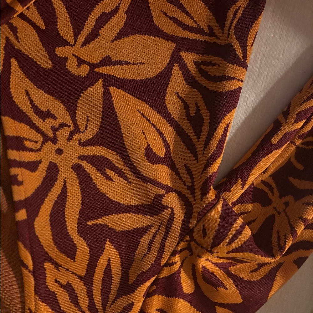 Orange and Burgundy Floral Patterned Fabric